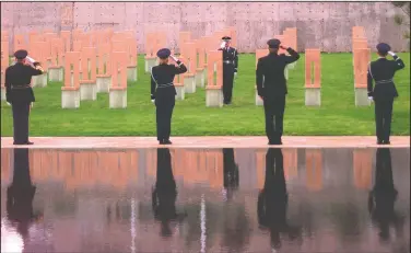 ??  ?? A color guard stands at the Field of Chairs during the dedication ceremony of the Oklahoma City National Memorial. (AP File/Jerry Laizure)