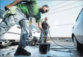  ?? Marcus Villagran ?? Las Vegas Review-journal @brokejourn­alist Brandon Steckler, left, and Manuel Serros, a car wash company owner, prepare soap Thursday at The Drop, 2770 E. Flamingo Road, for car wash fundraiser to help pay the funeral expenses for Brandon Steckler Jr.
