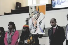  ?? AP PHOTO/GERALD HERBERT ?? Family members and supporters hold a photograph of Tyre Nichols at a news conference in Memphis, Tenn., on Jan. 23.