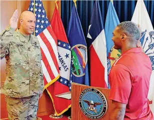  ?? [PHOTO BY MIREILLE MERILICERO­BERTS, FOR THE OKLAHOMAN] ?? Maj. Gen. Michael Thompson, adjutant general for Oklahoma, at left, administer­s to Rodney Rideaux an Oath of Enlistment to the Oklahoma Army National Guard. The enlistment took place June 29 at the Oklahoma Military Entrance Processing Station in...