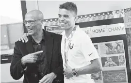  ?? JOSHUA MCKERROW/BALTIMORE SUN MEDIA GROUP ?? Olympic gold medal winner Matthew Centrowitz, right, laughs with his former running coach, Dana Dobbs, during an appearance at Broadneck on Monday.