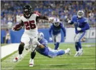  ?? RICK OSENTOSKI - THE ASSOCIATED PRESS ?? FILE - In this Sept. 24, 2017, file photo, Atlanta Falcons running back Tevin Coleman (26) is tackled by Detroit Lions strong safety Miles Killebrew (35) during the first half of an NFL football game in Detroit.