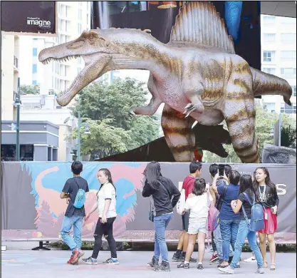  ?? KJ ROSALES ?? An animatroni­c dinosaur welcomes visitors to the Mind Museum in Taguig City. The museum is hosting ‘Dinosaurs Around the World,’ an internatio­nal traveling exhibition, from Sept. 1 to March 2, 2018.