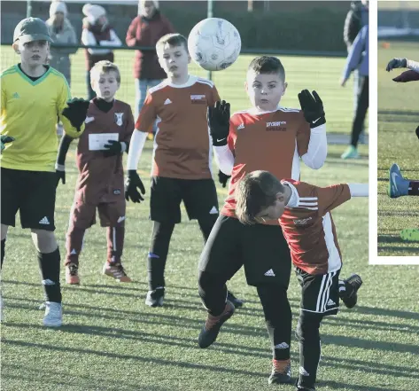  ??  ?? Consett AFC Roma Under-9s (dark red) taking on Foundation of Light.