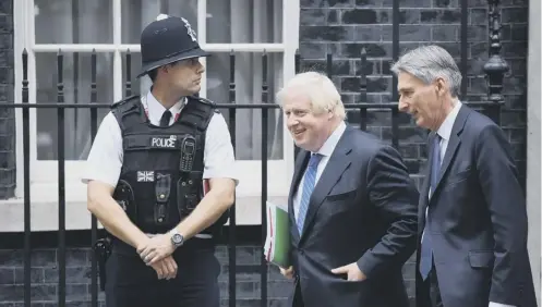  ?? PICTURE: CHRIS J RATCLIFFE ?? 0 Show of unity: Boris Johnson and Philip Hammond leave No10 together after the Cabinet meeting