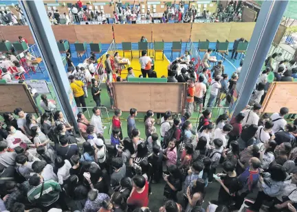  ??  ?? EXERCISING THEIR BALLOT: People turn up to cast their vote during advance voting ahead of the March 24 general election at Matthayom Ban Bang Kapi School in Bang Kapi district.