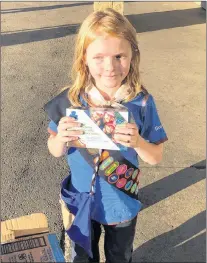  ?? SEANN CHILDS VIA CP ?? Nine-year-old Elina Childs poses as she sells Girl Guide Cookies outside a cannabis store in Edmonton on Wednesday.