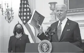  ?? MANDEL NGAN/AFP VIA GETTY IMAGES ?? President Joe Biden speaks about the COVID-19 response as Vice President Kamala Harris looks on before signing executive orders in the State Dining Room of the White House on Thursday.