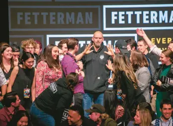  ?? TED SHAFFREY/AP ?? Democrat John Fetterman stands with his campaign staff after winning Pennsylvan­ia’s race for U.S. Senate in Pittsburgh on Wednesday.