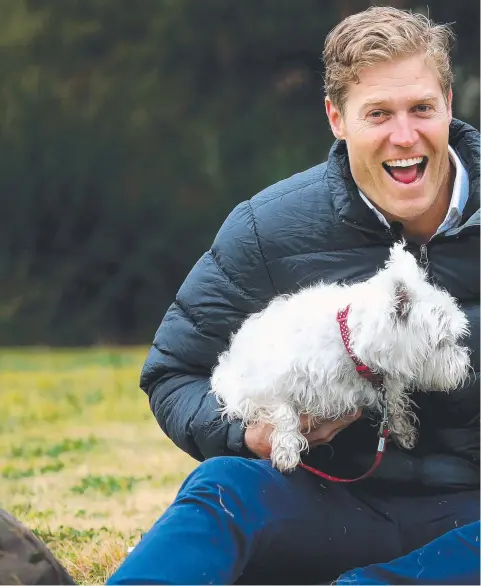  ??  ?? Celebrity vet Chris Brown with two West Highland White Terriers. Dr Brown says that pets have an important role in making better