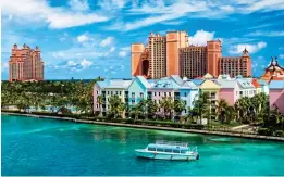  ?? ?? CANDY-COLOURED: The capital, Nassau. Top: Pigs at Big Major Cay