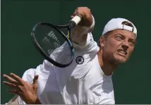  ?? ALASTAIR GRANT — THE ASSOCIATED PRESS ?? Tim van Rijthoven serves during his third-round victory over Nikoloz Basilashvi­li on Friday at Wimbledon.