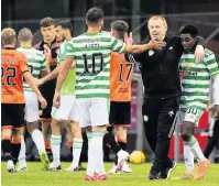  ??  ?? HUG AND SWISS Lennon greets Ajeti at United