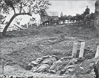  ??  ?? Confederat­e casualties of the Battle of Gettysburg lay in unfinished graves marked with boards, just as many did at Chickamaug­a. Graves were marked in whatever way possible – sometimes with stones or simply a regiment carved into a tree near a mass...