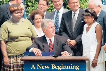  ?? J. SCOTT APPLEWHITE/AP ?? President Bill Clinton prepares to sign legislatio­n overhaulin­g America’s welfare system on Aug. 22, 1996, in the Rose Garden of the White House.