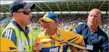  ??  ?? RED CARD: A Clare supporter is escorted from the pitch