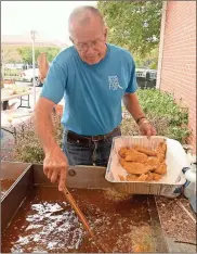  ??  ?? Volunteer Ben Harrison fries up fillets at the 2017 CRBI Fish Fry. Organizers expect to feed more than 700 at this year’s fry. / CRBI