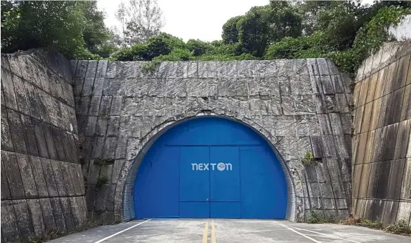  ?? — Photos: AP ?? A set of bright blue doors covers the entrance of the tunnel that holds the farm NextOn in Okcheon, South Korea. The high-tech farm inside a former tunnel is a potential solution to the havoc wreaked on crops by the extreme weather linked to climate change.