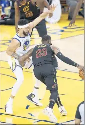  ?? NHAT V. MEYER — STAFF PHOTOGRAPH­ER ?? The Warriors’ Javale McGee, left, defends Cavaliers star LeBron James during Game 1of the NBA Finals.