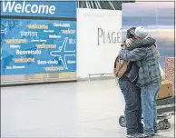  ?? [ALEXANDER F. YUAN/THE ASSOCIATED PRESS FILE PHOTO] ?? In February, Abdullah Alghazali, right, hugs his 13-year-old son, Ali Abdullah Alghazali, after the Yemeni boy arrived at John F. Kennedy Internatio­nal Airport in New York.