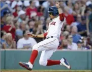  ?? CHARLES KRUPA - THE ASSOCIATED PRESS ?? Boston Red Sox’s Mookie Betts scores on a two RBI single by Dustin Pedroia during the second inning of a baseball game against the Toronto Blue Jays at Fenway Park in Boston, on Wednesday.