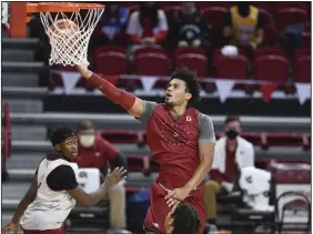  ?? (NWA Democrat-Gazette/Charlie Kaijo) ?? Forward Justin Smith (center) is one of three scholarshi­p seniors on the Arkansas men’s basketball roster this season. Smith transferre­d to Arkansas from Indiana, where he averaged 10.4 points and 5.2 rebounds in 32 games in 2019-20.