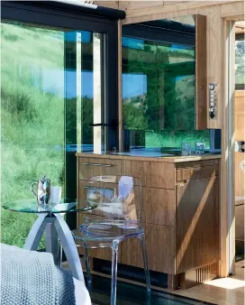  ??  ?? CLOCKWISE FROM TOP: A Perspex headboard is another design touch that ensures the view is sacrosanct; the upmarket loo with a view is a luxury take on the classic Kiwi dunny; although compact, the cabin is well equipped with crockery, cutlery and...