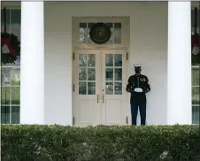  ?? EVAN VUCCI — THE ASSOCIATED PRESS ?? A Marine stands outside the entrance to the West Wing of the White House, signifying the President is in the Oval Office, Monday, Dec. 21, 2020, in Washington.
