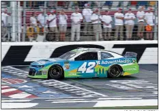  ?? AP/CHUCK BURTON ?? Kyle Larson takes the checkered flag to win the final segment of the Monster Energy Open on Saturday at Charlotte Motor Speedway in Concord, N.C. Larson also won the All-Star Race, which showcased technical changes NASCAR experiment­ed with.