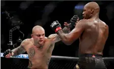  ?? AP Photo/John Locher ?? In this 2019 file photo, Anthony Smith, left, hits Jon Jones in a light heavyweigh­t mixed martial arts title bout at UFC 235 in Las Vegas.