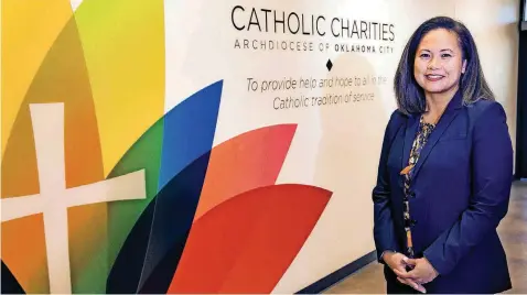  ?? [PHOTO BY CHRIS LANDSBERGE­R, THE OKLAHOMAN] ?? President of the Catholic Charities of OKC board of directors, and Vietnamese immigrant, Vi Le, poses for a photo at the Catholic Charities’ office on Aug. 31 in Oklahoma City.