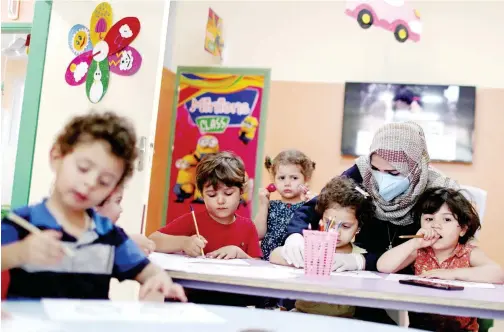  ?? Reuters ?? ↑ Children attend a drawing activity in a nursery school as Gaza City eased restrictio­ns on Wednesday.