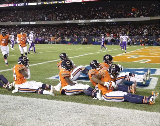  ?? JONATHAN DANIEL/GETTY IMAGES ?? Wide receiver Anthony Miller (right) leads his teammates in celebratio­n after his 18-yard touchdown catch in the second quarter.