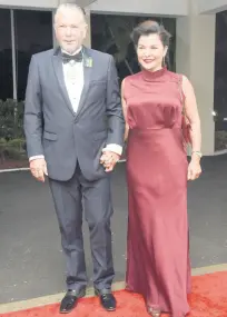  ?? ?? Tom TavaresFin­son, president of the senate, with his wife Rose who was donning a Le Trunkshop find which went seamlessly with her Salvatore Ferragamo handbag and shoes.