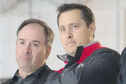  ?? ADRIAN WYLD/THE CANADIAN PRESS ?? Senators general manager Pierre Dorion, left, says head coach Guy Boucher is staying despite the team’s recent string of poor results. “We’re not making any coaching changes,” Dorion said Wednesday before the Senators’ 3-2 victory against the New York Rangers.