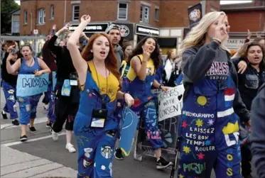  ?? CATHIE COWARD, THE HAMILTON SPECTATOR ?? McMaster University students take part in a pyjama parade to WestFest in Westdale Saturday night. The parade and a concert by Darby was the wrapup to Welcome Week for students, another sure sign of the looming end of summer.