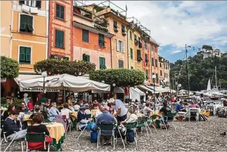  ??  ?? Visitors absorb the best of La dolce vita at the harbour on Portofino, Italy.