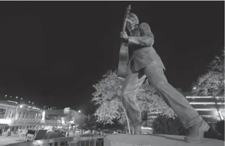  ?? VASHA HUNT/TENNESSEE DEPARTMENT OF TOURISM ?? The statue of Elvis overlookin­g Beale St. is one of many sights that go with the sounds of blues, soul and rock ’n’ roll in Memphis.