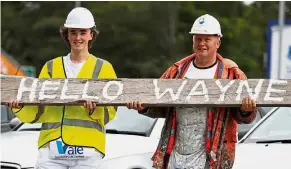  ??  ?? Great news: Workers holding up a sign to welcome Wayne Rooney to Everton on Monday.