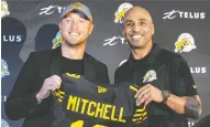  ?? PHOTO COURTESY OF THE HAMILTON TIGER-CATS ?? Tiger-Cats head coach Orlondo Steinauer, right, was all smiles when he helped introduce former all-star and Calgary Stampeder quarterbac­k Bo Levi Mitchell to the Hamilton media and fans after the pivot agreed
to a three-year deal with the Ticats.