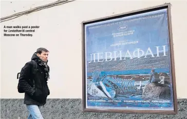  ??  ?? A man walks past a poster for Leviathan in central Moscow on Thursday.