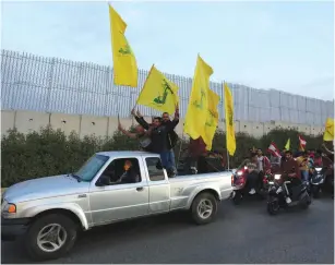  ?? (Aziz Taher/Reuters) ?? SUPPORTERS OF Hezbollah leader Hassan Nasrallah ride in a convoy last week in the village of Kfar Kila, near the border with Israel.