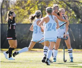  ?? BRIAN KRISTA/FOR CAPITAL GAZETTE ?? South River's Allison Corey, right, is embraced by teammate McKenzie Jamison after scoring the opening goal against Dulaney in the Class 4A field hockey state championsh­ip game at Washington College on Saturday.