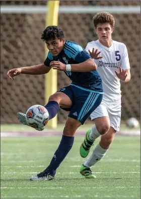  ?? NWA Democrat-Gazette/ANTHONY REYES • @NWATONYR ?? Jesus Zizumbo (left) of Springdale Har-Ber passes the ball forward as Jonah Glover of Fayettevil­le defends Tuesday at Harmon Field in Fayettevil­le. The Wildcats won 3-1.