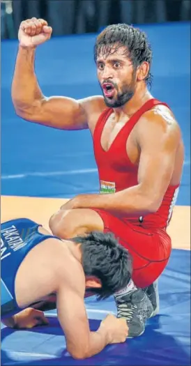  ?? PTI ?? ▪ Bajrang Punia gestures defeating Japan's Daichi Takatani in the 65kg wrestling final on Sunday.