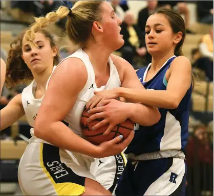  ?? PHOTOS BY MATTHEW B. MOWERY — MEDIANEWS GROUP ?? Rochester’s Lucy Cook, right, tries to pull the ball away from Hartland’s Sarah Rekowski in a non-conference game on Wednesday. Hartland became just the second team in 15 games to score more than 35 points on the defensive-minded Rochester Falcons, pulling away for a 4928 win.