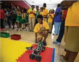  ?? Annie Mulligan ?? Beatrice Mayes Institute student Jeremy Johnson sets up his team’s robot during the 2017 C-STEM Challenge on Saturday at the Health Museum of Houston. “They’ve got to be exposed,” said Reagan Flowers, the competitio­n’s founder.