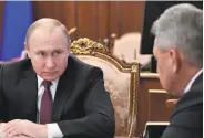  ?? Alexei Nikolsky / Sputnik ?? Russian President Vladimir Putin (left) confers with Defense Minister Sergei Shoigu in Moscow.