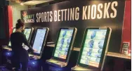  ?? Susan Haigh / Associated Press ?? Zach Young, of New Haven, places a bet at a sports wagering kiosk at Foxwoods Resort Casino in Mashantuck­et.