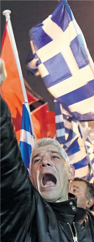  ?? Picture Yannis Kolesidis/ap ?? Golden Dawn supporter makes Nazi salute at a rally in Athens